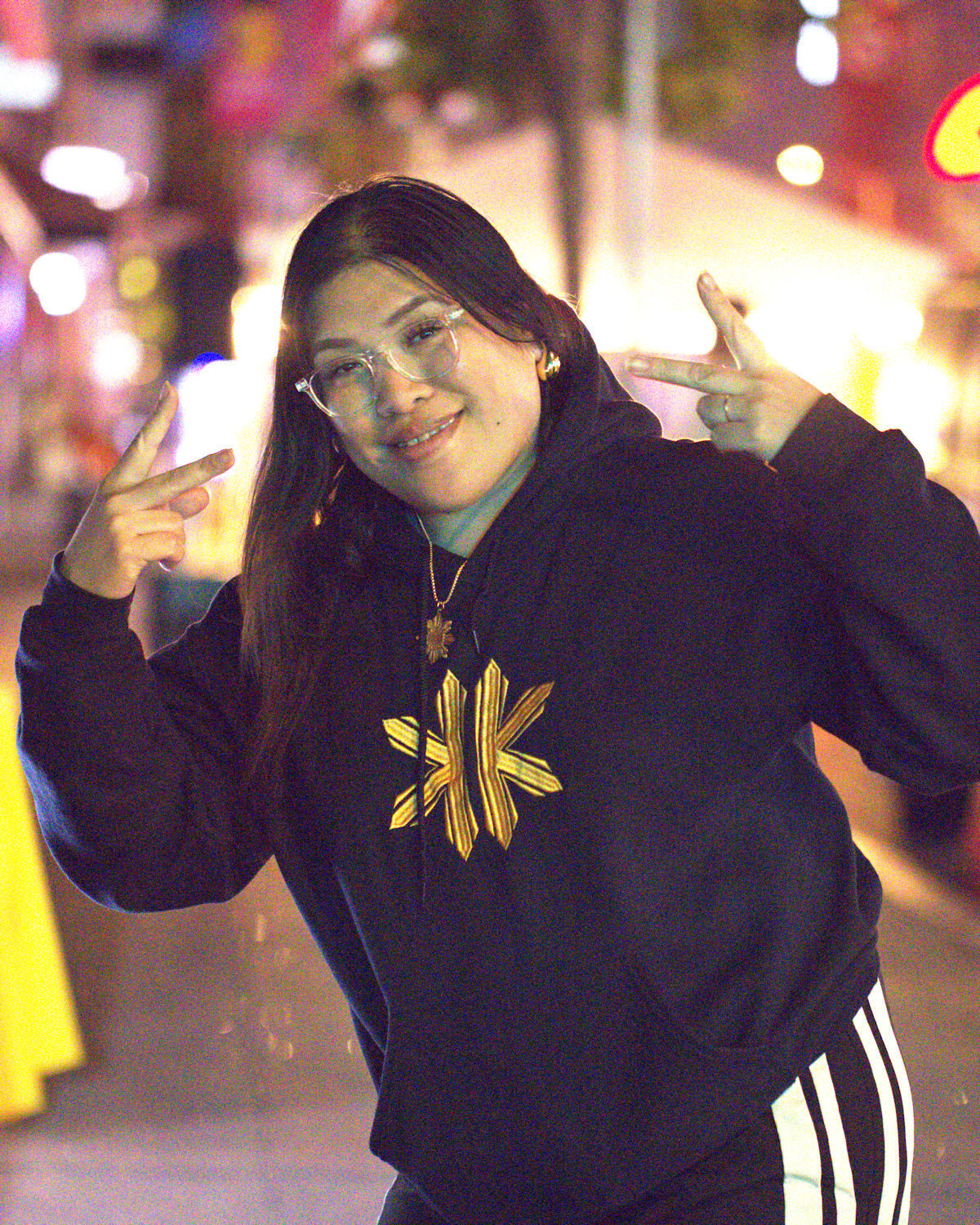 Shauna wearing both the gold Lakas Tribal Necklace and Classic Kapwa Kultura Hoodie