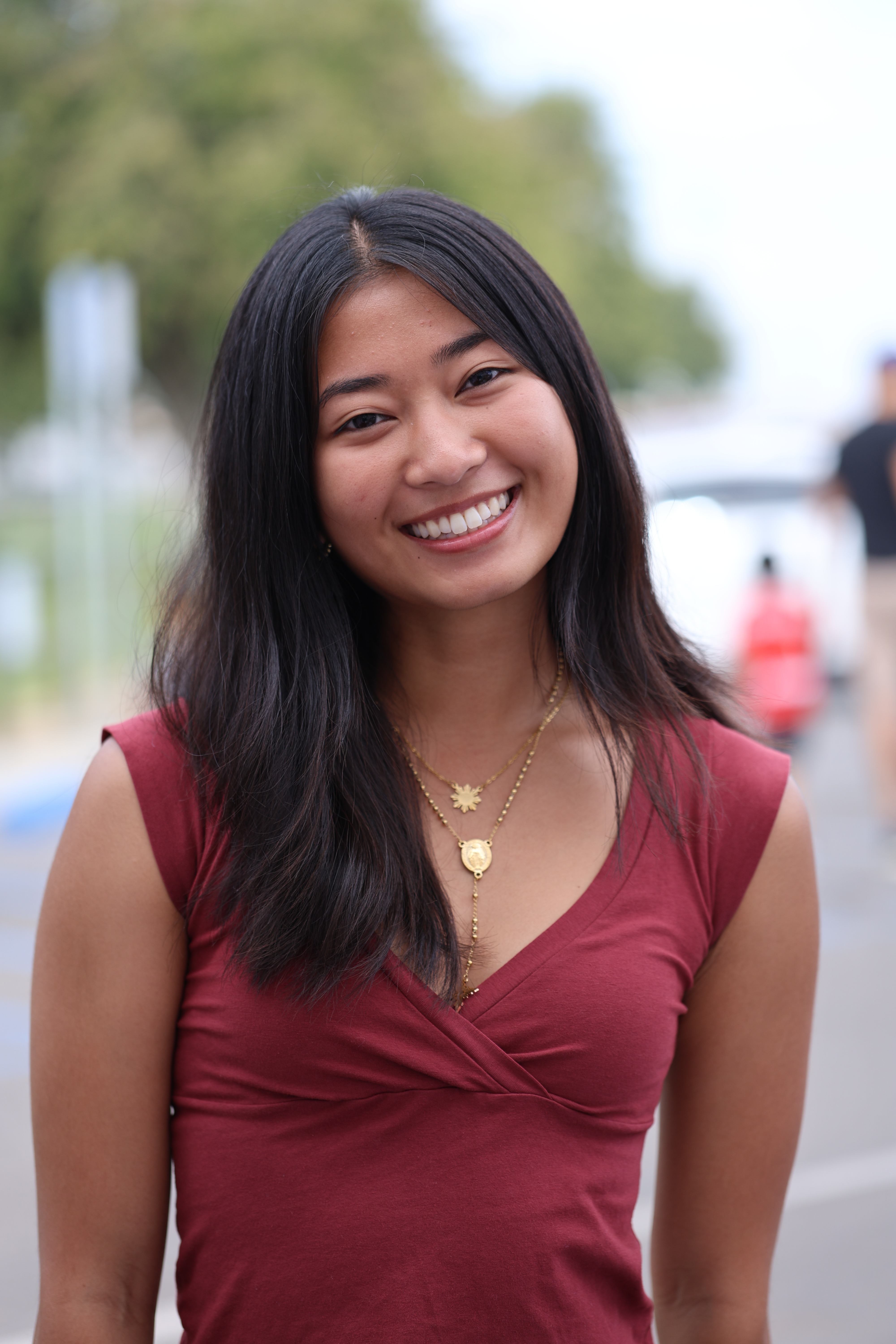 Young woman wearing the smaller gold Dasal Rosary Necklace at Philippine Weekend in Delano