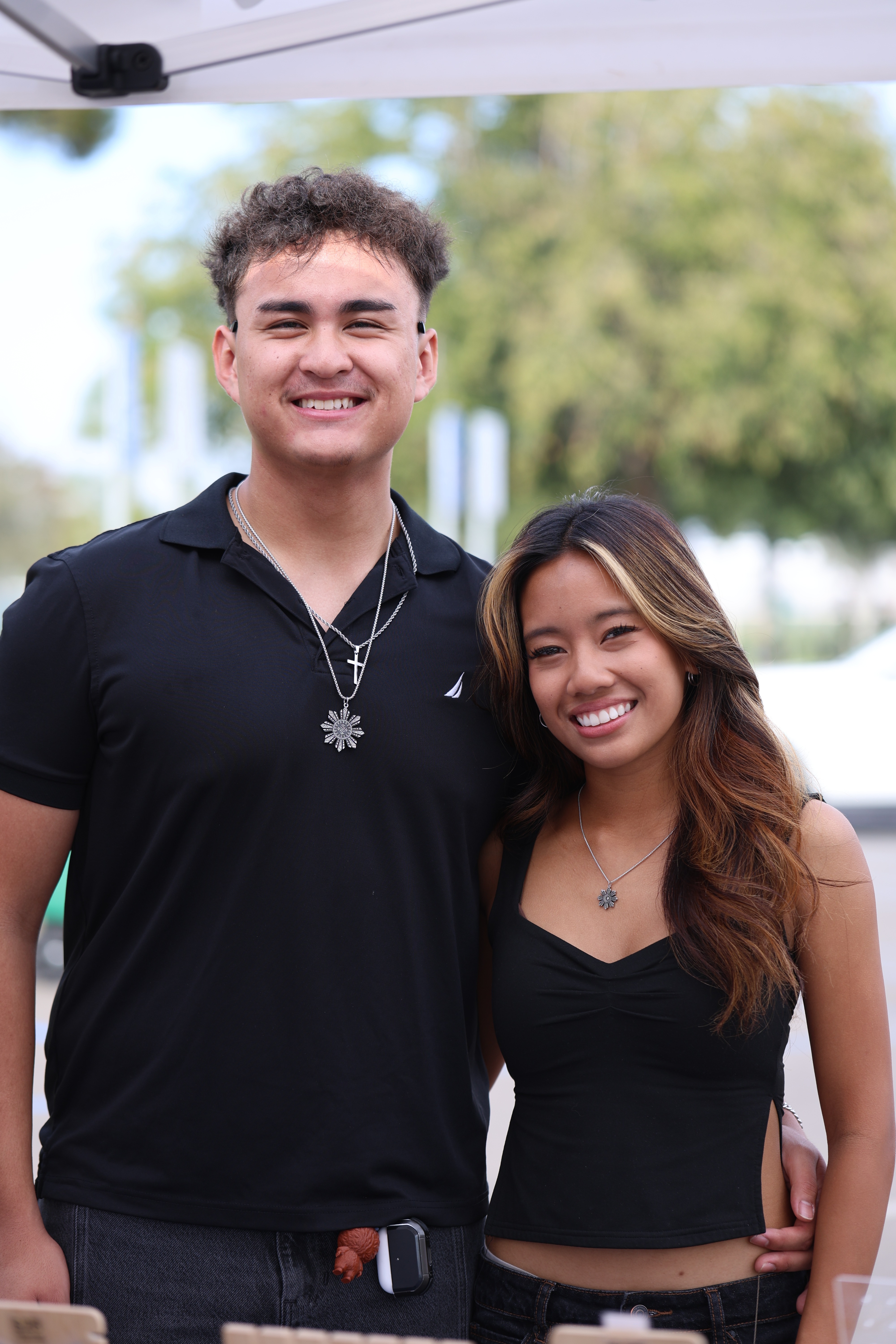A couple wearing the black Lakas Tribal Necklace and black Diwa Tribal Necklace from Philippine Weekend in Delano