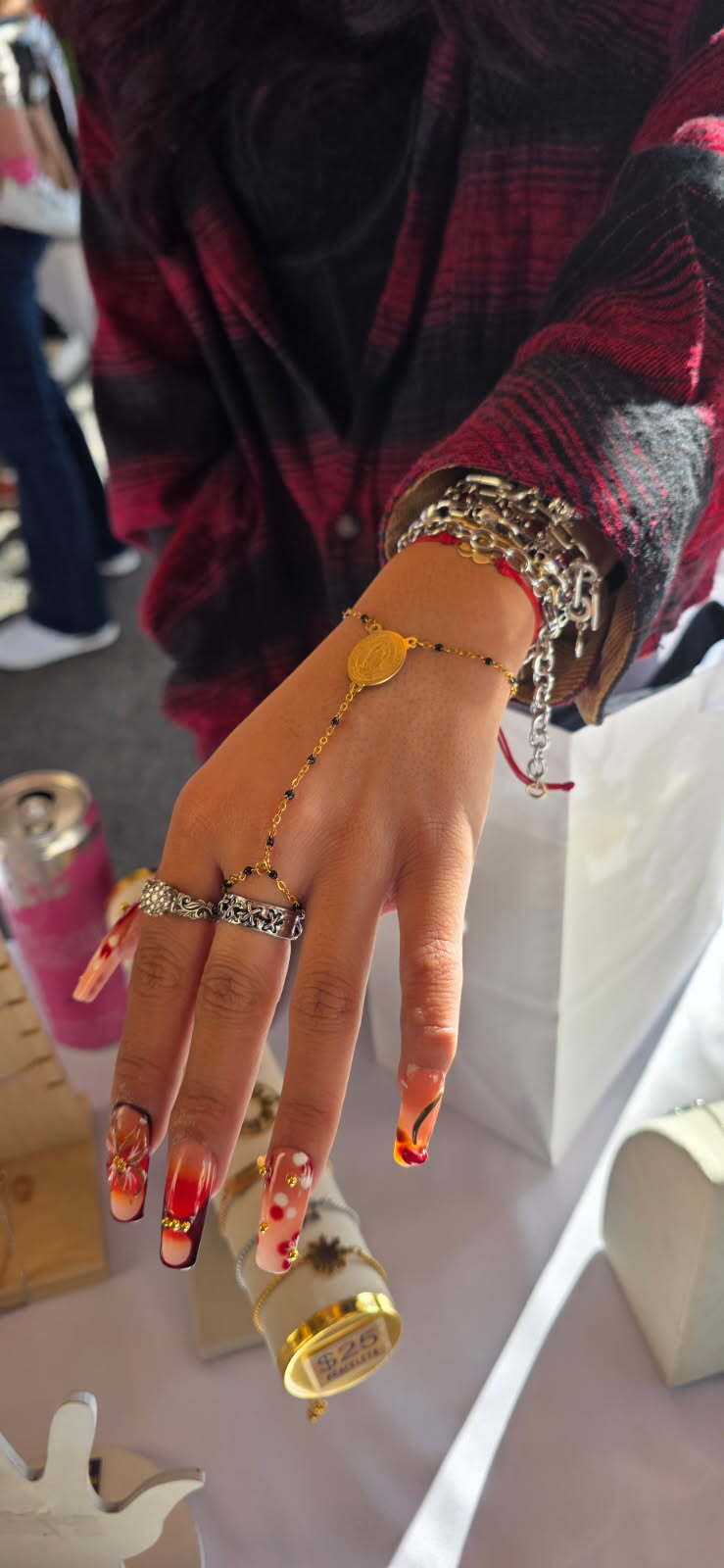 Young woman stacking the black Dasal Hand Rosary from a pop-up at Bag of Beans coffee shop