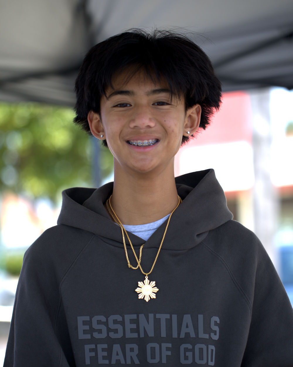 Young man wearing the Gold Lakas Tribal Necklace at the National City Flea